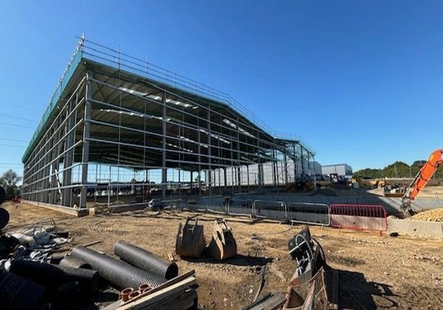 Large steel building warehouse during construction.